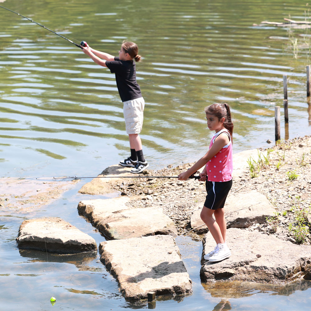 Kids fishing at Tifft from rocks