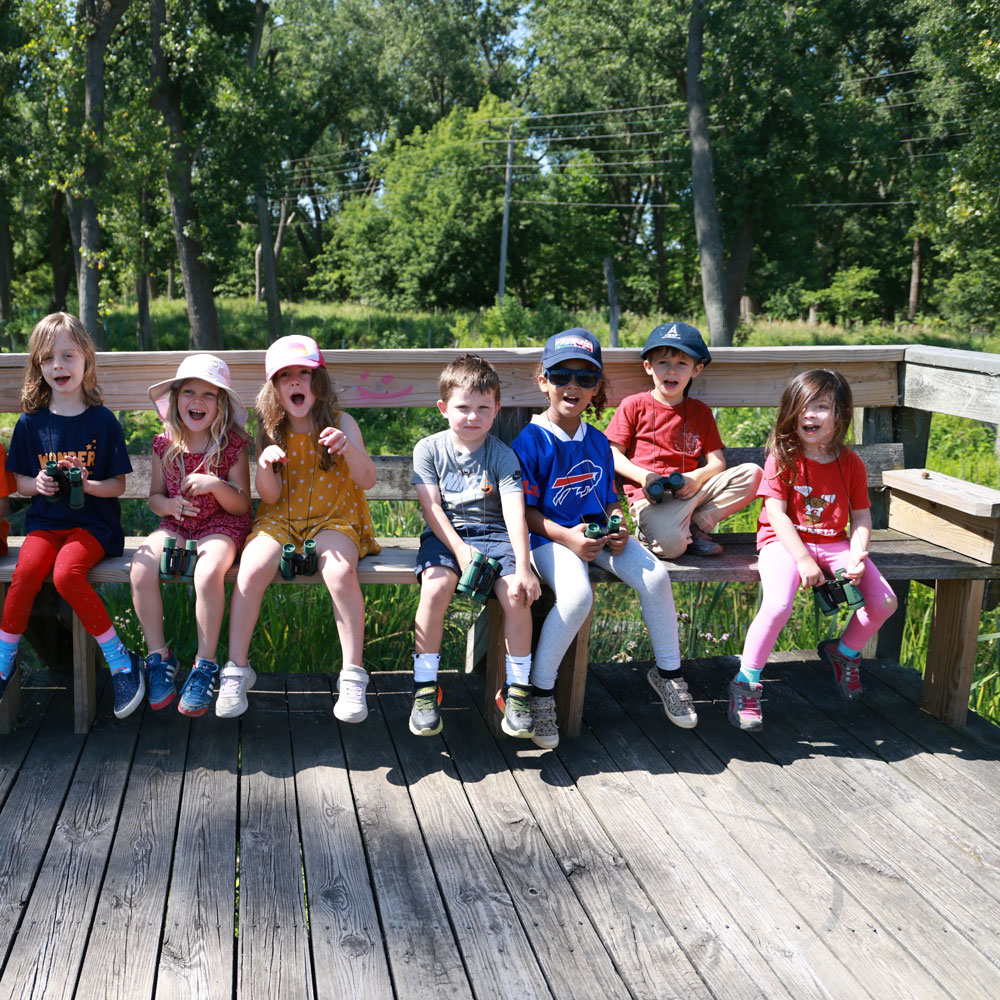 Group of kids seated on bench